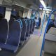 A row of dark blue seats on a train.