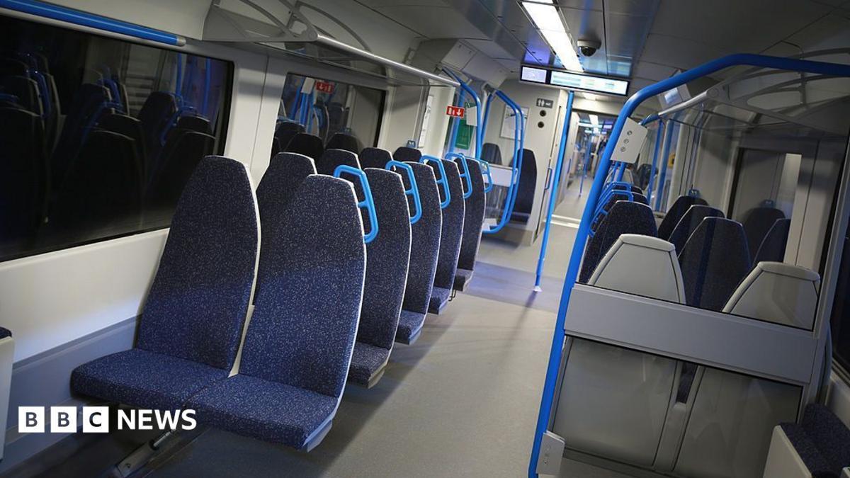 A row of dark blue seats on a train.