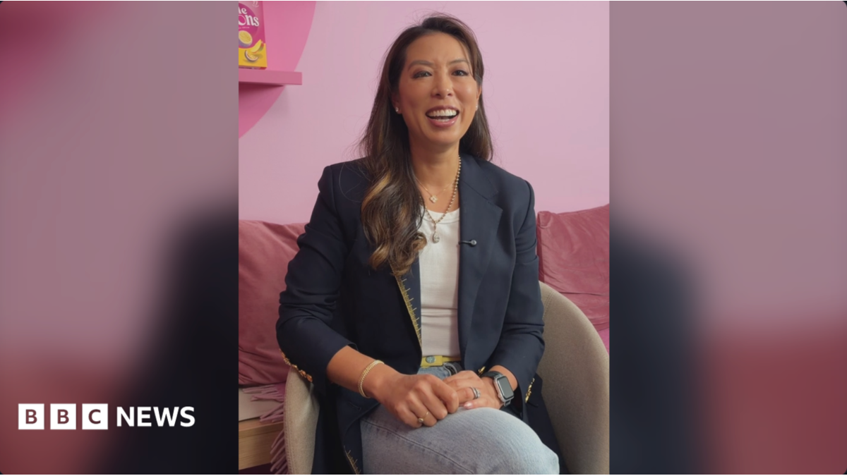 The co-founder of Little Moons, Vivien Wong smiles. She wears a blue blazer and jeans and has long, straight brown hair.
