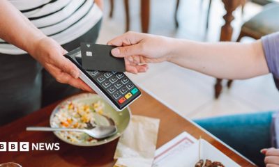 A person pays with a credit card in a restaurant