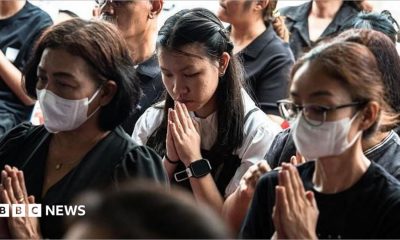 Women praying, some wearing face masks