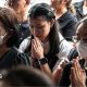 Women praying, some wearing face masks