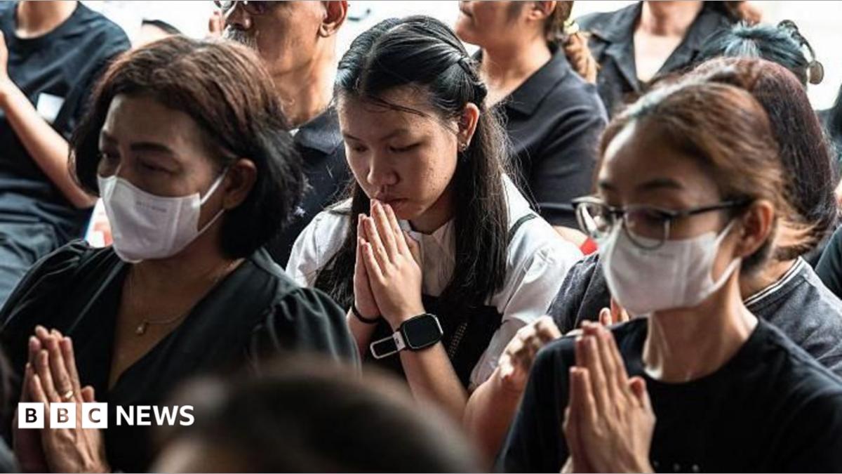 Women praying, some wearing face masks