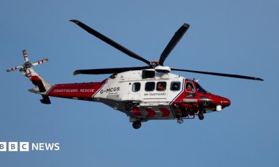 A coastguard helicopter in red and white livery