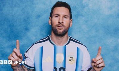 Lionel Messi poses in a photoshoot, with the index fingers of both hands pointing upwards
