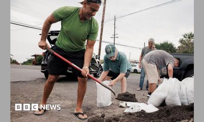 Captain Hook, Hawaii residents prepare stuff bags with sand in preparation of Tropical Storm Lala on Friday