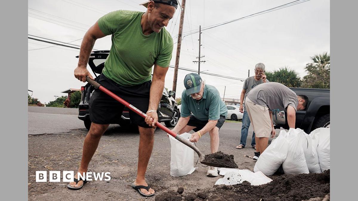 Captain Hook, Hawaii residents prepare stuff bags with sand in preparation of Tropical Storm Lala on Friday