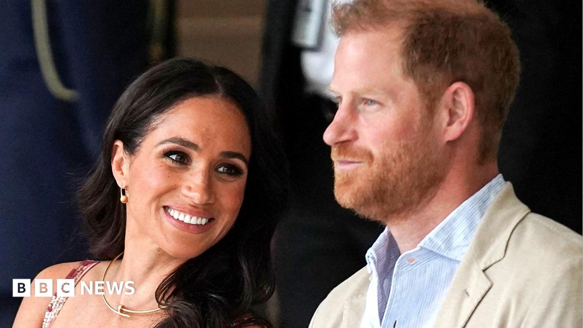 Prince Harry and Meghan sat next to each other and smiling in Colombia in 2024