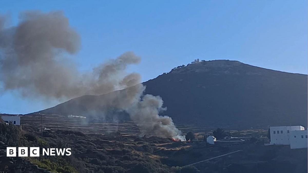 A few people are seen working at a blackened site on a mountain