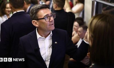 Andy Burnham reacts as he stands in a metro carriage among passengers during the journey between the metro stations Zoloti Vorota and Lukanivska on August 24, 2026 in Kyiv, Ukraine.