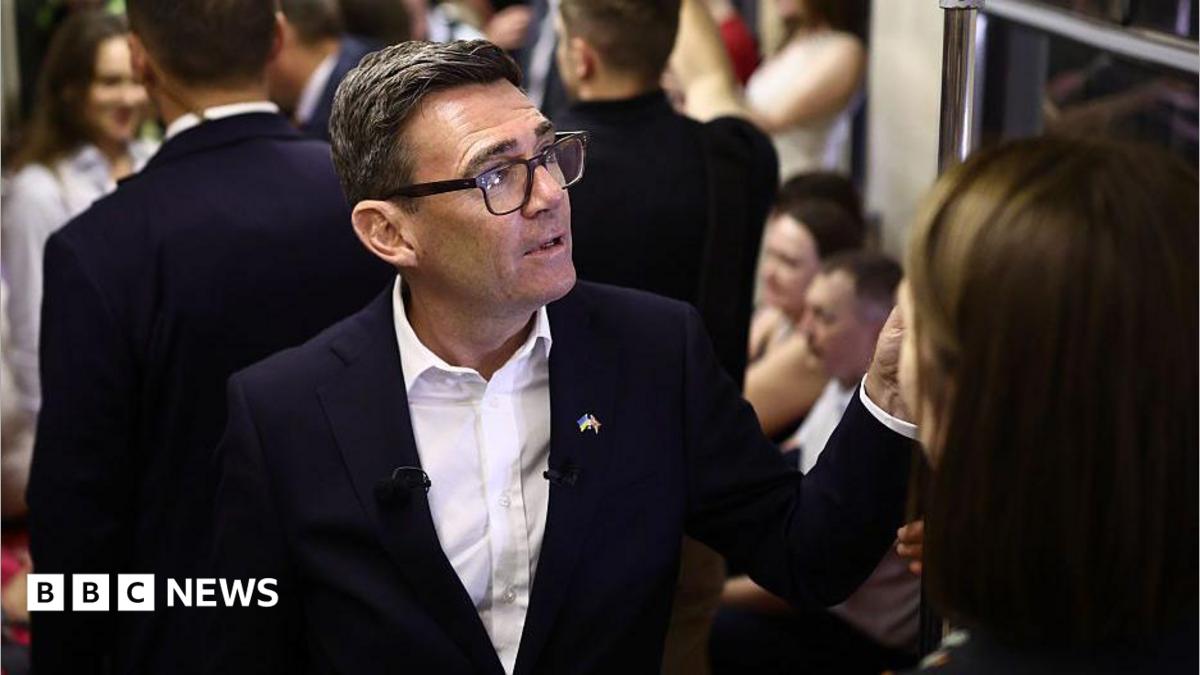Andy Burnham reacts as he stands in a metro carriage among passengers during the journey between the metro stations Zoloti Vorota and Lukanivska on August 24, 2026 in Kyiv, Ukraine.