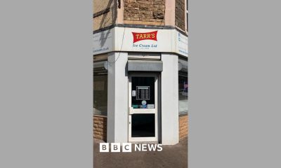 The front of an ice cream shop, painted white with a red and yellow logo reading Tarr's