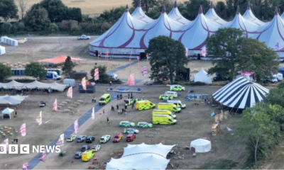 An electric green sign telling people at the festival the show has been cancelled.