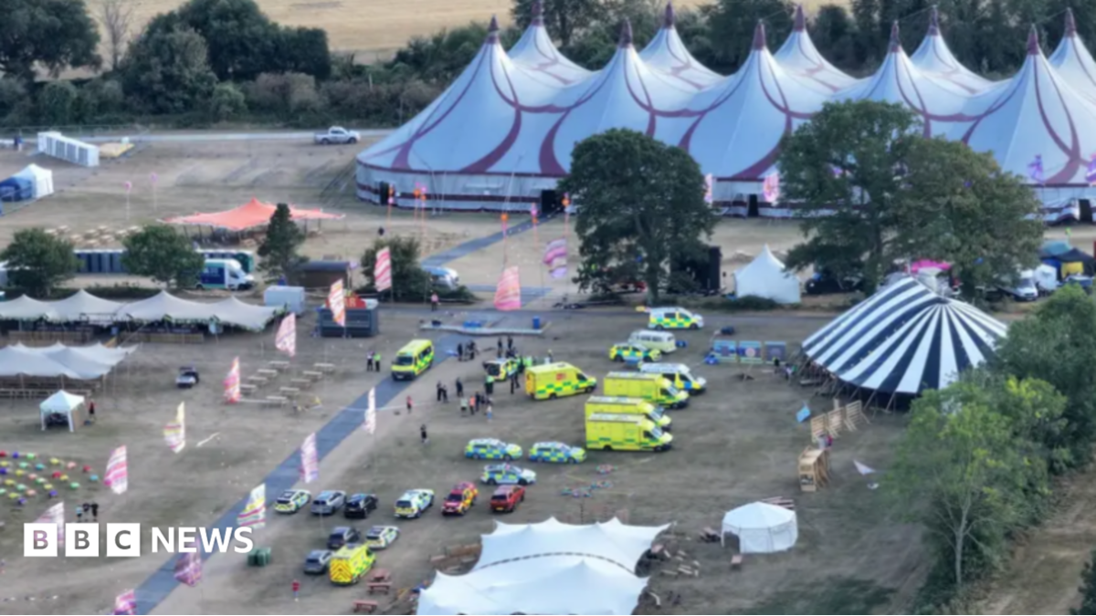 An electric green sign telling people at the festival the show has been cancelled.