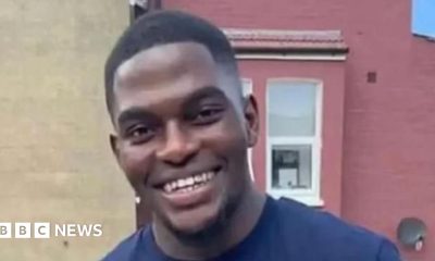 File image of Chris Kaba, a young man with short hair wearing a blue T-shirt and smiling at the camera.