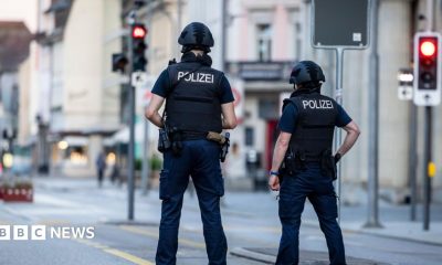Police officers patroll a street in downtown Aarau
