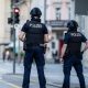 Police officers patroll a street in downtown Aarau