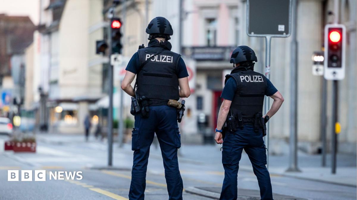 Police officers patroll a street in downtown Aarau