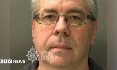 A mugshot of Christopher Phillips, who has grey hair and glasses