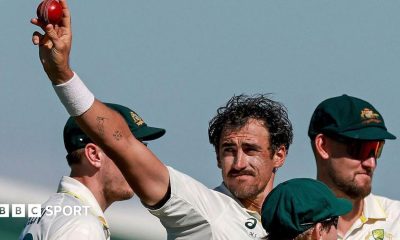 Australia cricketer Mitchell Starc celebrates his 10th wicket in the match by holding the ball up