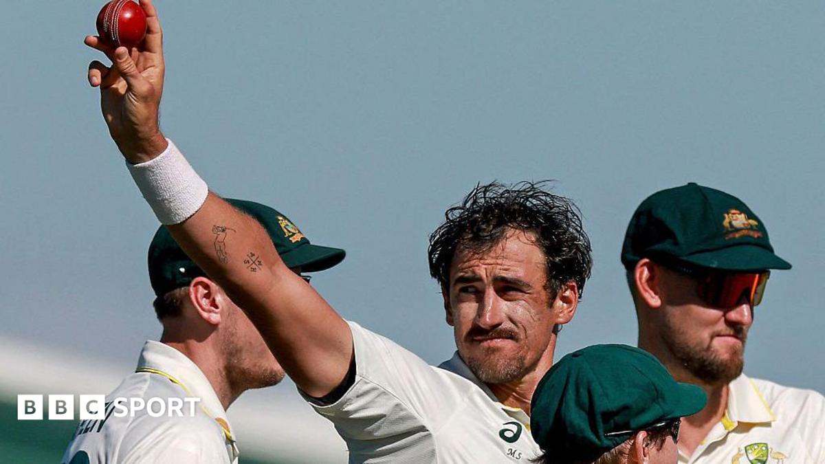 Australia cricketer Mitchell Starc celebrates his 10th wicket in the match by holding the ball up