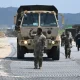 A U.S. Marine leads a military vehicle at a beach during a joint field training exercise conducted by the South Korea-US Combined Forces Command in Pohang on July 15, 2026.