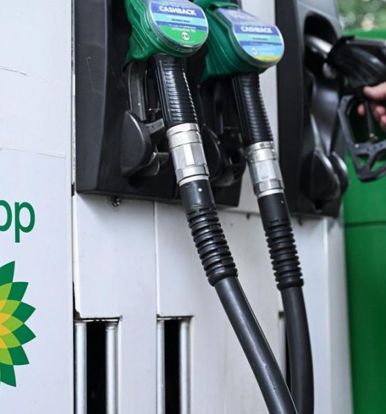 Close up of petrol and diesel pumps and hand on one of the pumps with the BP logo to the side