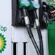 Close up of petrol and diesel pumps and hand on one of the pumps with the BP logo to the side