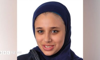 A headshot photo of Sara El-Khawas wearing a hijab and looking at the camera smiling against a white background.