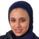 A headshot photo of Sara El-Khawas wearing a hijab and looking at the camera smiling against a white background.