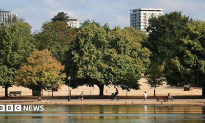 People walk, run and cycle through the parched park lands of Hyde Park during the drought in central London.