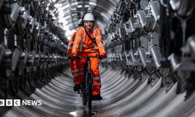 Four engineers stand close to a large metal cylinder which containers the Earthgrid boring machine.