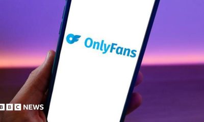 A phone with the OnlyFans logo on the screen