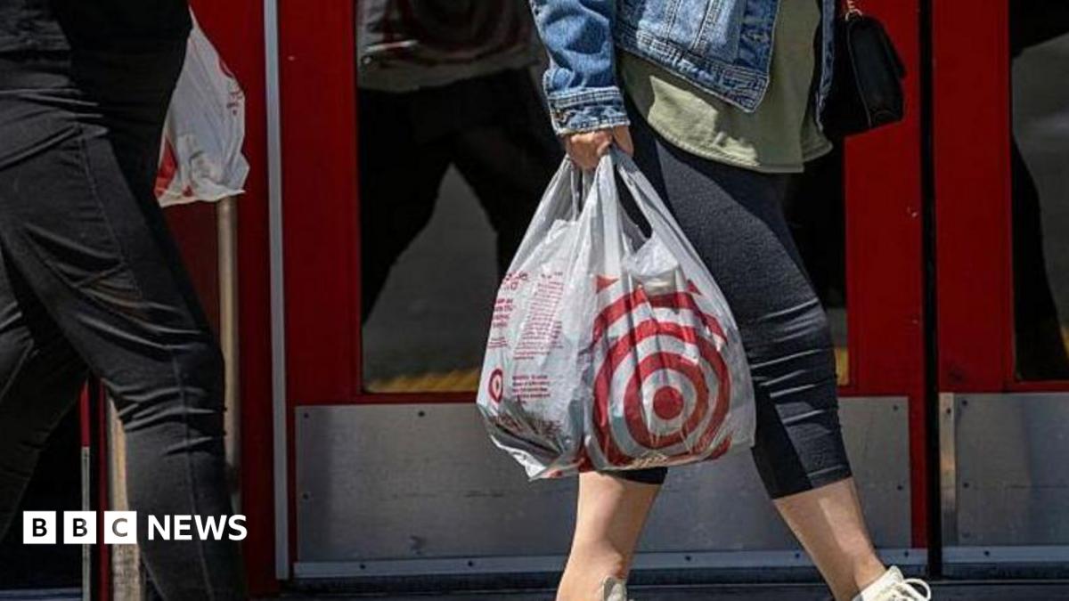 A person walking out of Target with a bag