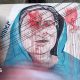 Vehicles move past graffiti depicting former Bangladeshi Prime Minister Sheikh Hasina in Dhaka