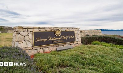A sign for Trump's golf course overlooks a bluff in California