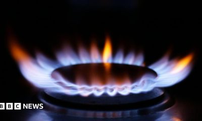 A close up of a ring on a gas cooker with blue flame burning