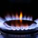 A close up of a ring on a gas cooker with blue flame burning