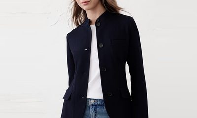 A woman wearing blue jeans, a white top, and navy blazer