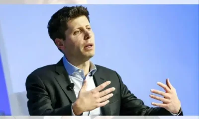 Sam Altman, CEO of OpenAI, mid-speech sat down with his hands gesturing