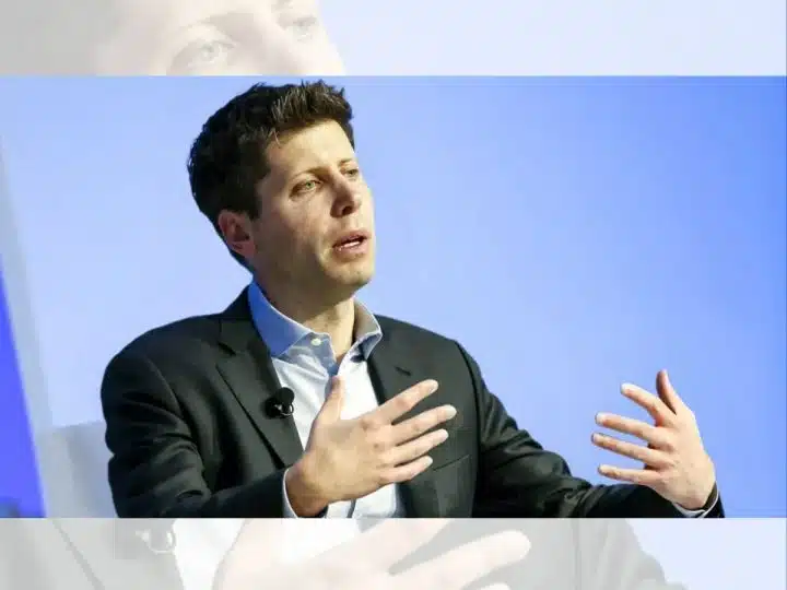 Sam Altman, CEO of OpenAI, mid-speech sat down with his hands gesturing