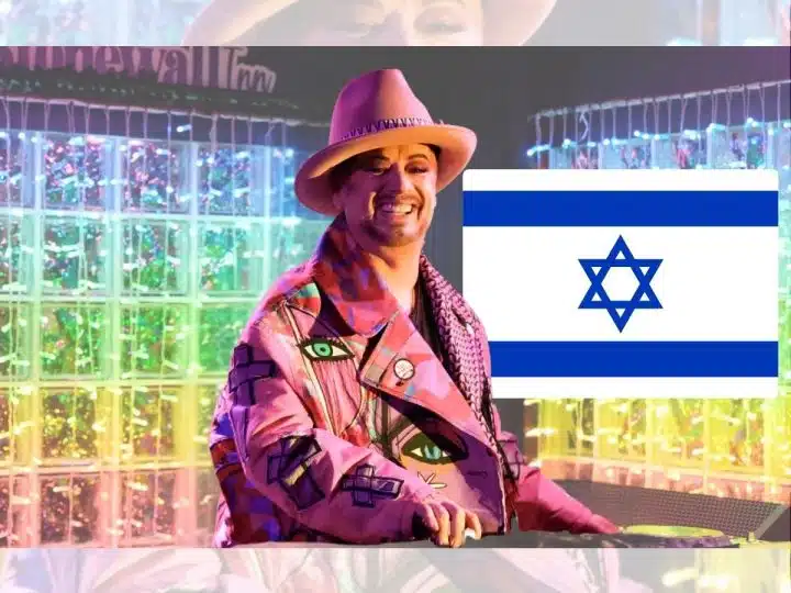 Boy George and the flag of Israel on one side with rainbow-coloured lights in the background of the image