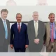 Rupert Lowe of Restore Britain and Nigel Farage of Reform UK standing with other politicians in a line for a photo op