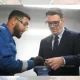 Prime Minister Andy Burnham meets apprentices as he visits Submarine Academy for Skills and Knowledge (SASK) at BAE Systems, on July 30, 2026 in Barrow in Furness, United Kingdom. Both he and the apprentice are in workshop goggles.