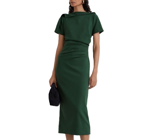 A woman wearing a dark green midi dress, carrying a black handbag