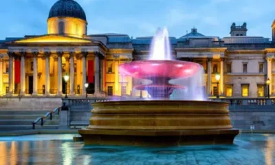 Outside the National Gallery in London in the evening when it's illuminated with lights and so is the large water fountain outside. Workers are experiencing racially divided break facilities at the historic institution