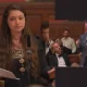 Screenshots from the YouTube video of the Oxford Union debate with Arwa Elrayess on the left and an inset photo of Tommy Robinson, suited and booted, speaking with Laurence Fox sat next to him in black tie