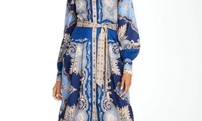 A woman wearing a blue/multicolored shirtdress