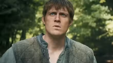 Dunk the Tall looking up at something with his brows furrowed in A Knight of the Seven Kingdoms.