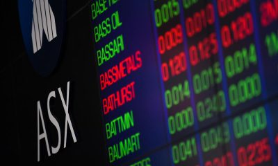 Aussie shares edge higher as iron ore tumbles